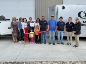 Charron Lawn Care snips Chamber ribbon Friday afternoon